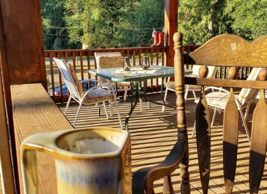 Hot coffee, a relaxing rocker, a good magazine and sunshine on the deck outside the John Wayne room.